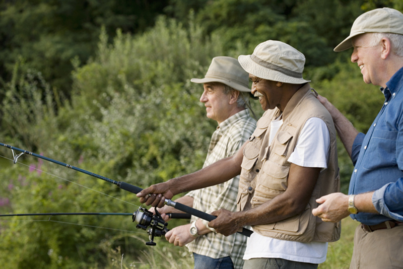 3 happy senior men fishing