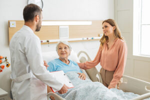 Woman talking with doctor to advocate during a hospitalization for her elderly mother