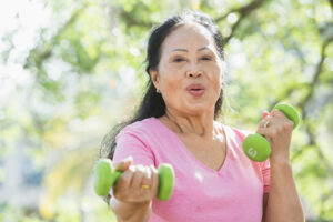 A woman exercises outside knowing that regular physical activity is part of stroke prevention for seniors.