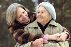 The dedication of family caregivers is obvious as an older woman embraces her elderly mother.