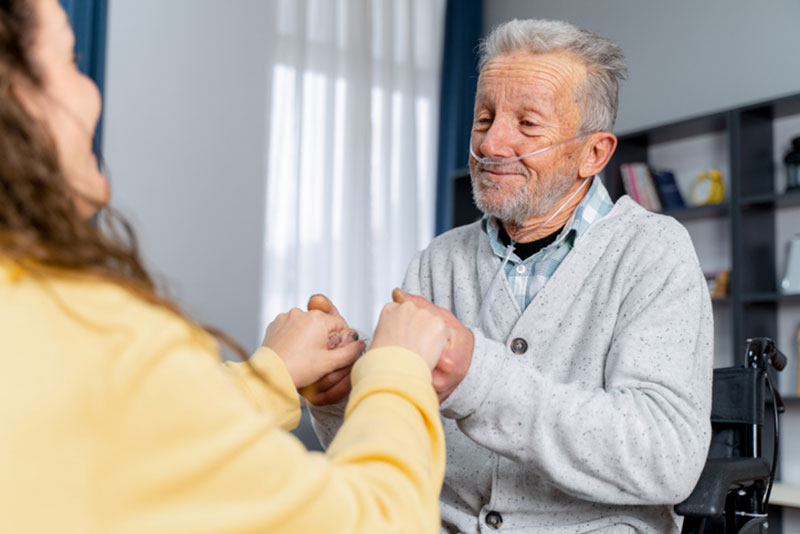 A family caregiver uses COPD management tips to help her aging father breathe easier at home.